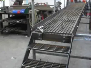 Industrial steel grating staircase with safety railing